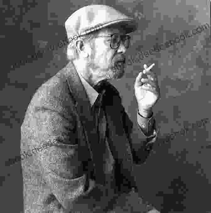 A Black And White Portrait Of Elmore Leonard, Seated At A Table, Holding A Pen In His Right Hand And A Cigarette In His Left. He Wears Glasses And Has A Mischievous Expression On His Face. Fire In The Hole: Stories (Raylan Givens 4)