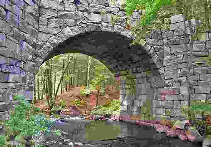 A Long And Narrow Canal Bridge With Stone Archways Spanning A River, Surrounded By Lush Greenery New York Central Timetable April 30 1950: The Scenic Water Level Route